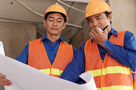 Construction workers looking at a blueprint